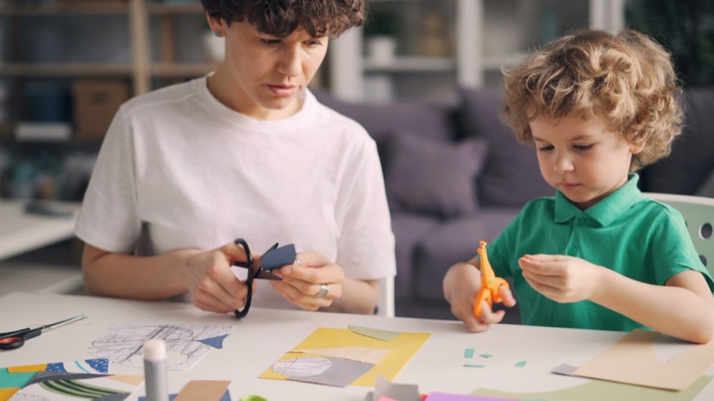 Two boys making crafts together