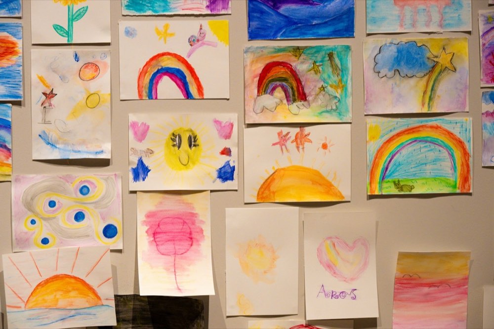 A wall of colorful children's drawings